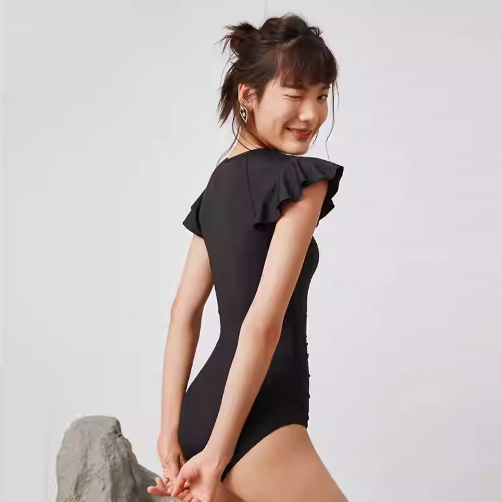 SBSS211W18P7B -Women's stylish black swimsuit with flattering belly design, showcasing European and American curves for a slimming effect.